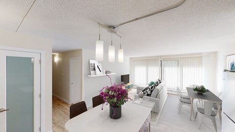 a living room and dining room with a white table and chairs