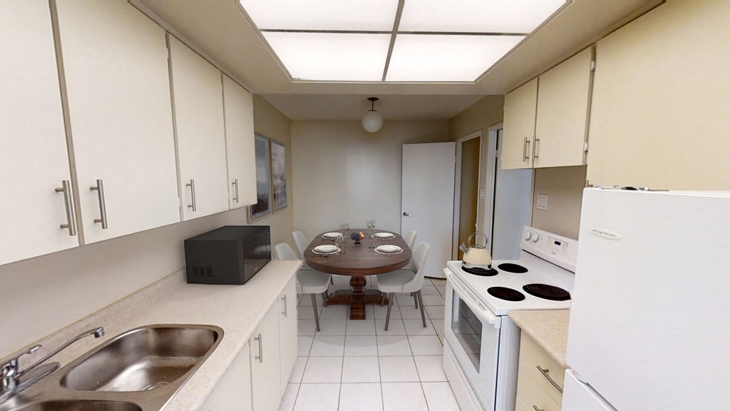 Kitchen with fridge, oven, microwave, and counter space