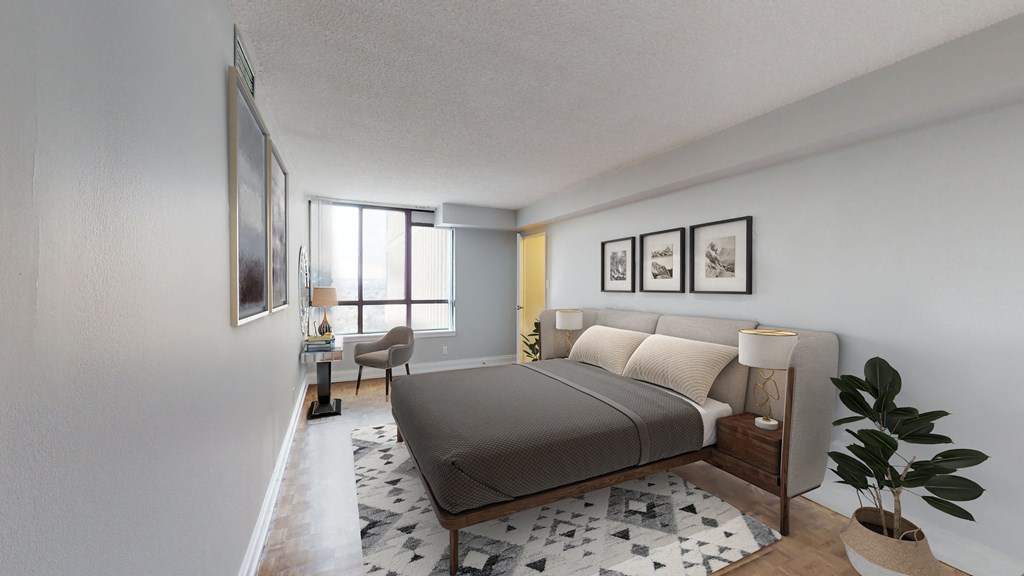 A bedroom with a large bed and a chair by the window.