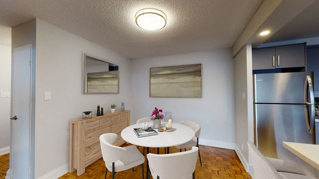 A kitchen with a table and chairs in the middle of the room.