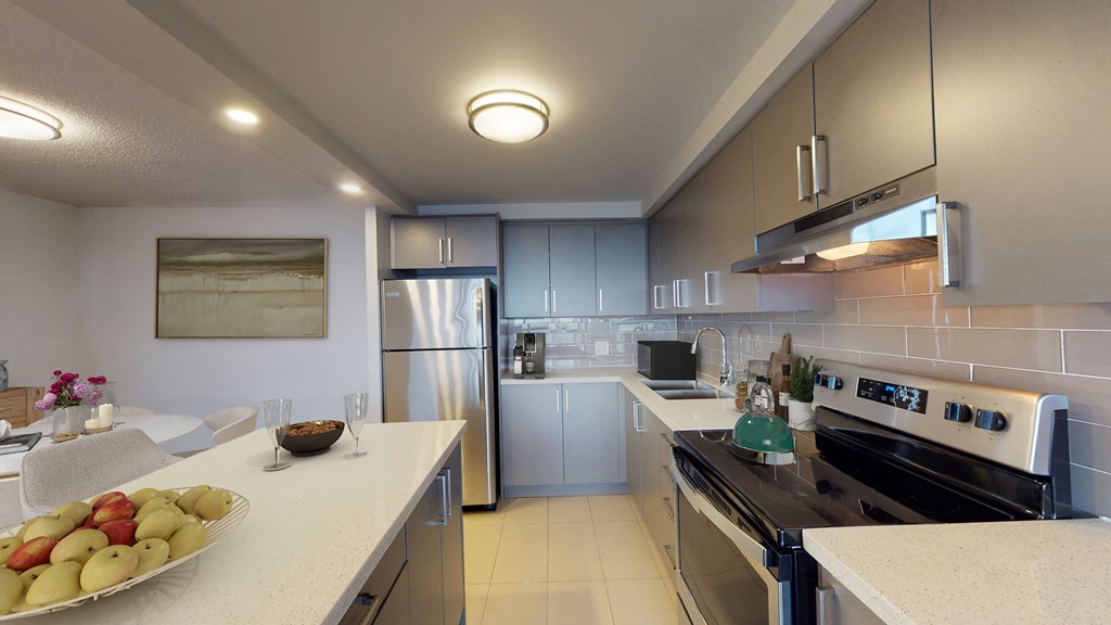Kitchen with fridge, oven, microwave, and counter space