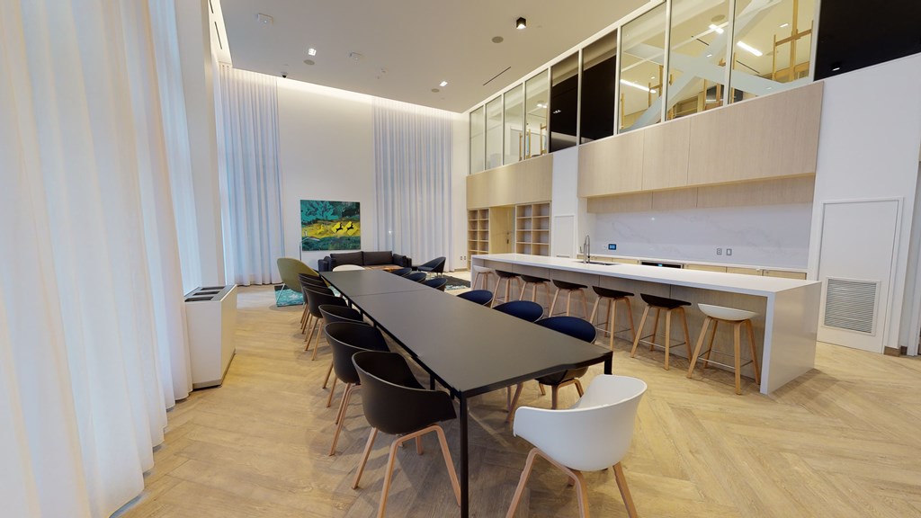 A conference room with a long table and chairs.