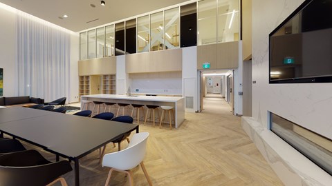 A conference room with a long table and chairs.