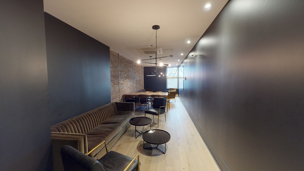 a long hallway with couches and tables and chairs