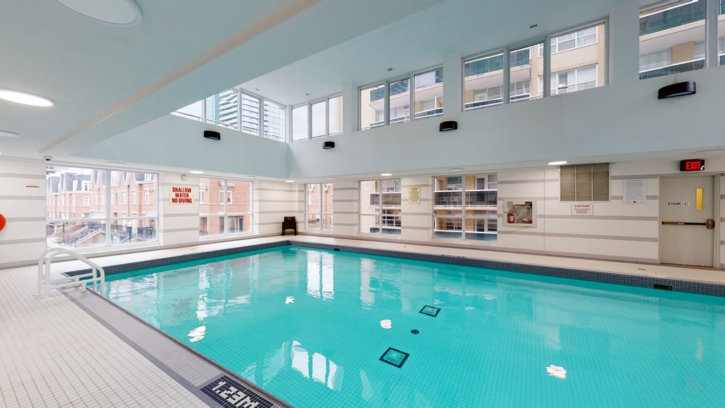 a swimming pool in a building with windows and a large