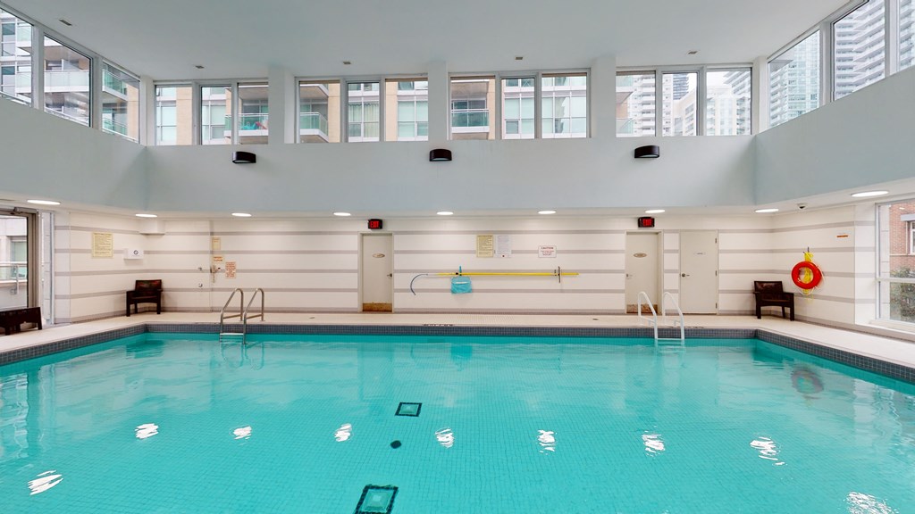 a swimming pool in a building with a large pool of water