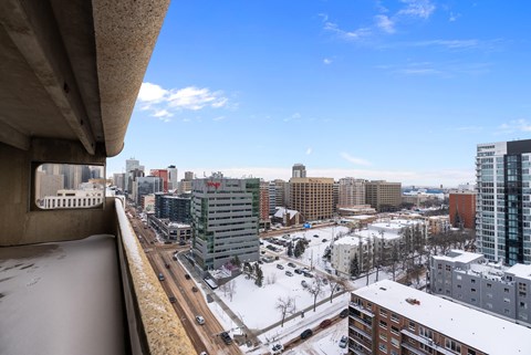 A cityscape with buildings and roads covered in snow.