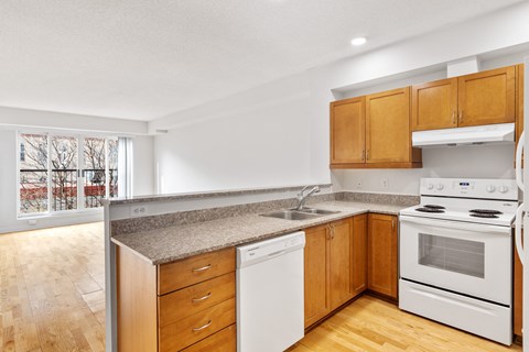 A kitchen with wooden cabinets and white appliances.