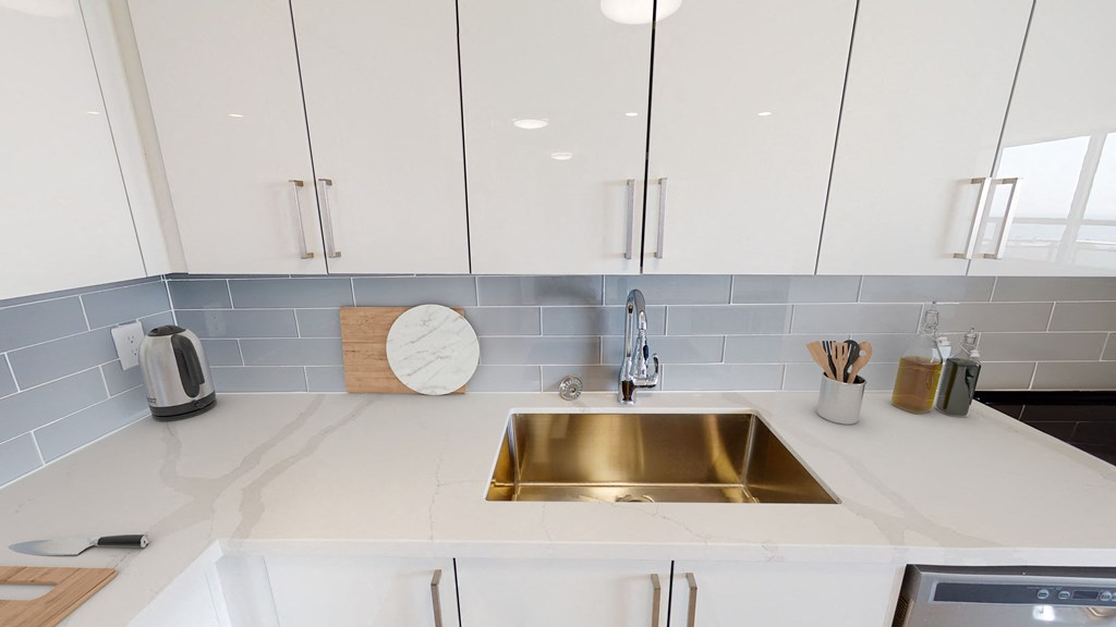White kitchen counter and sink. Thumbnail click to zoom