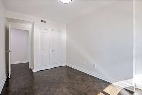 A bedroom with closet at a bathroom with a toilet and a sink and a mirror at A shower with a glass door at 50 Prince Arthur