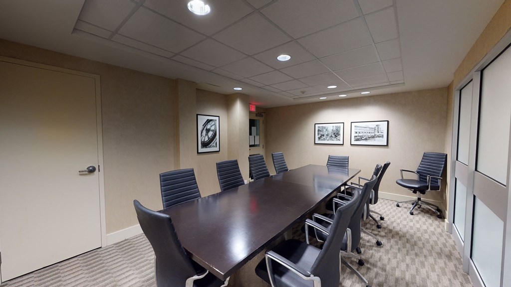 a small conference room with a long table and chairs