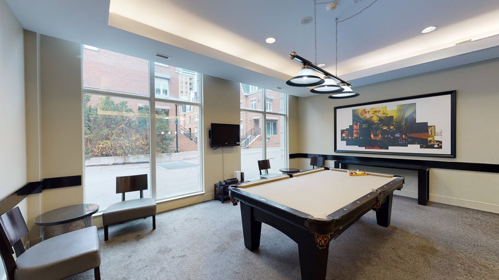 a rec room with a pool table and tv