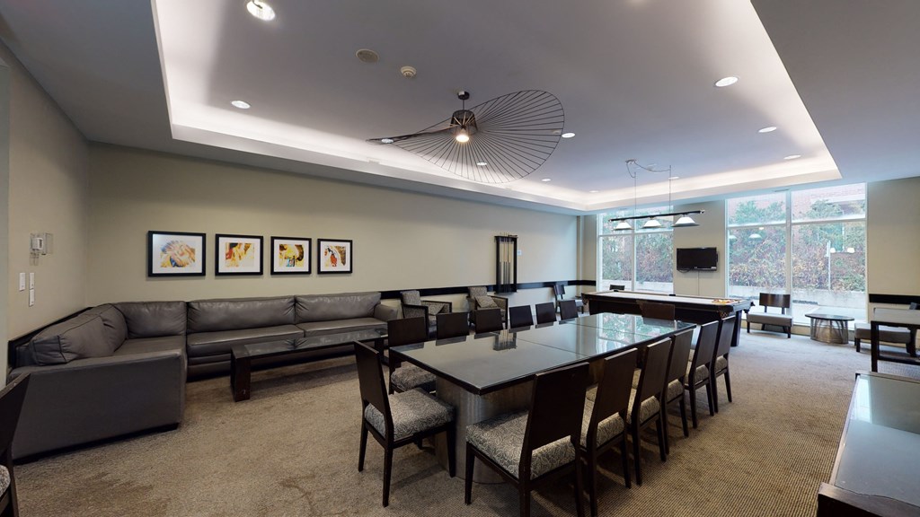 a conference room with a long table and couches