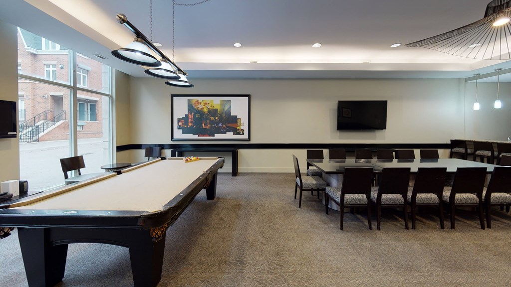 a large room with a pool table and a flat screen tv