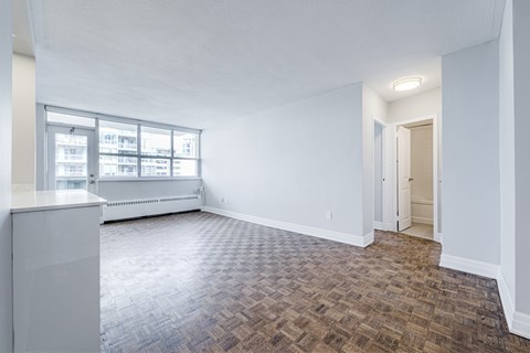 A room with a brown floor and white walls.