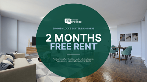 A room with a couch and a table with a sign offering 2 months free rent.