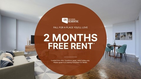 A room with a sofa and a table with a sign offering 2 months free rent.
