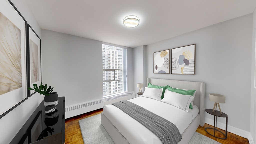 A bedroom with a large bed, a window, and a painting on the wall.