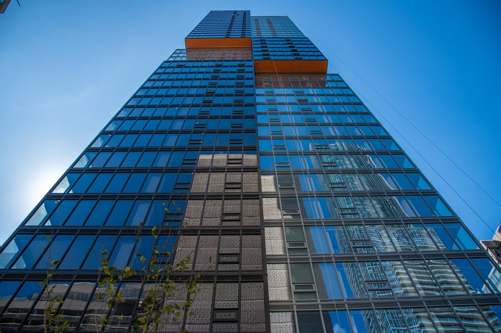 the top of a tall building with blue sky in the background