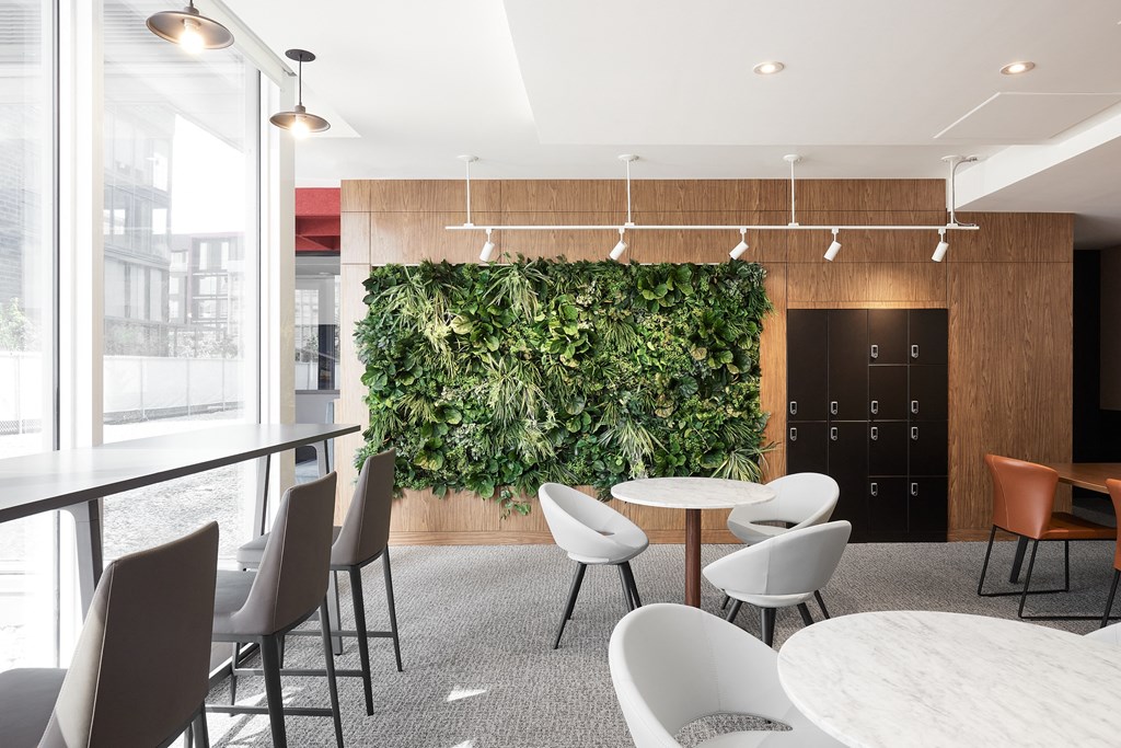 A room with a green wall and chairs.