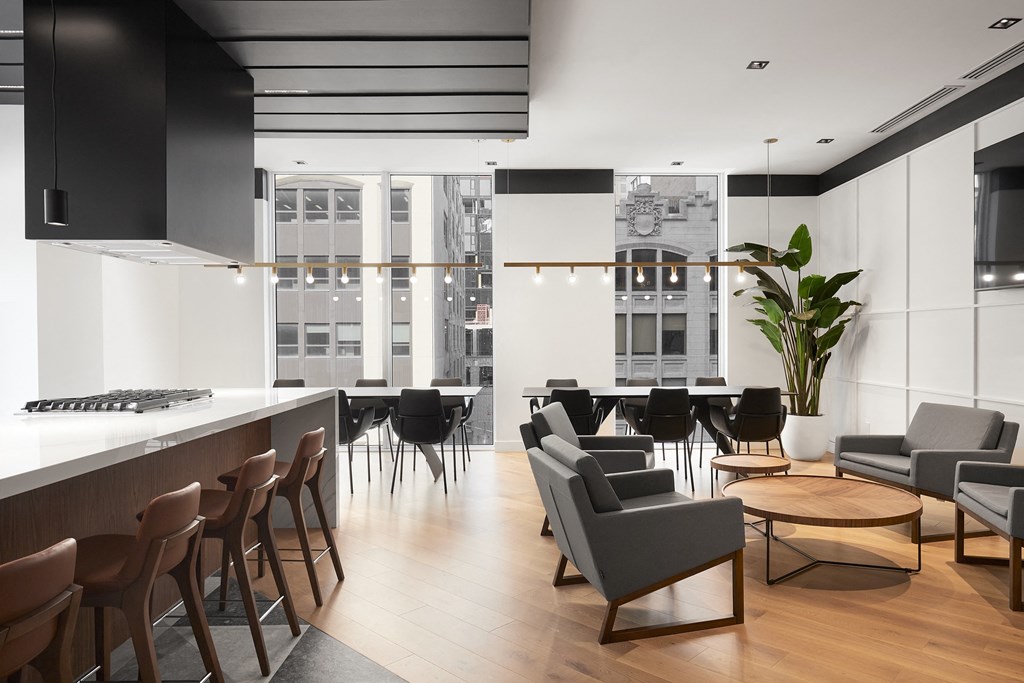 A modern living room with black and brown furniture.
