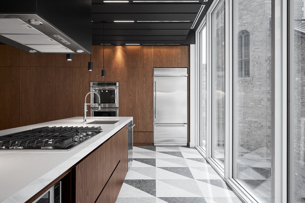 A modern kitchen with a black and white checkered floor.