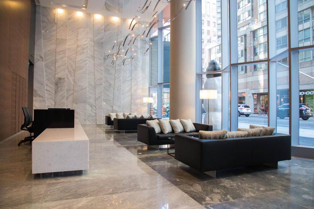 A large room with black furniture and a marble floor.