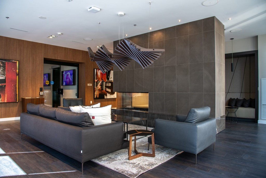 A modern living room with a grey sofa and a wooden coffee table.