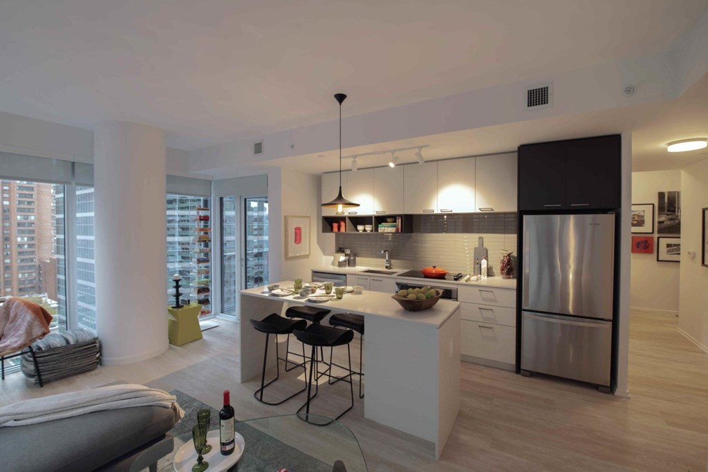 A modern kitchen with a dining table and chairs.