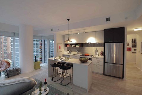 A modern kitchen with a dining table and chairs.