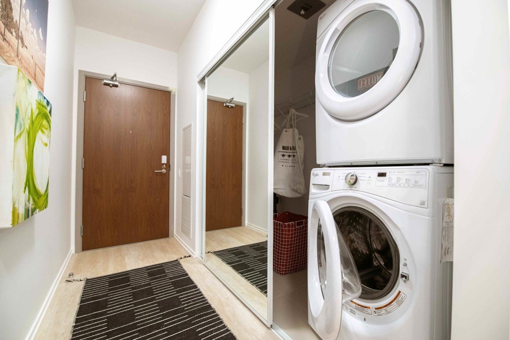 A washing machine is open in a small laundry room.