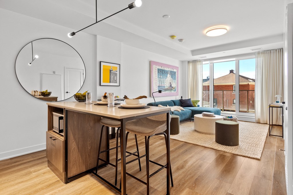 a living room with a bar with two stools