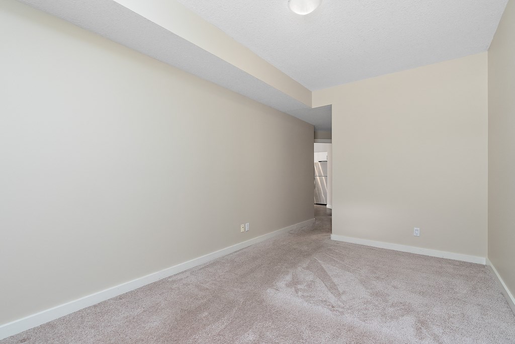 A room with a carpeted floor and a white ceiling.