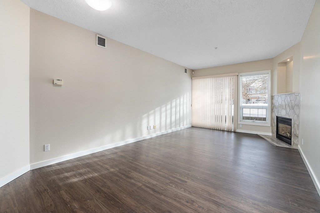 A room with a fireplace and sliding glass doors.