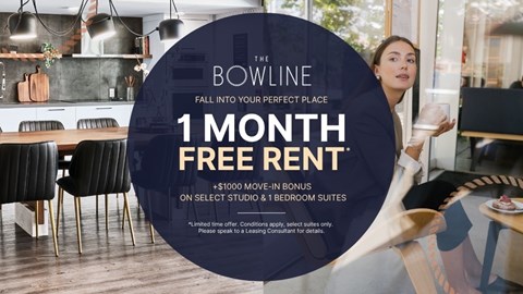 A woman is holding a glass in a modern kitchen with a 1 month free rent offer.