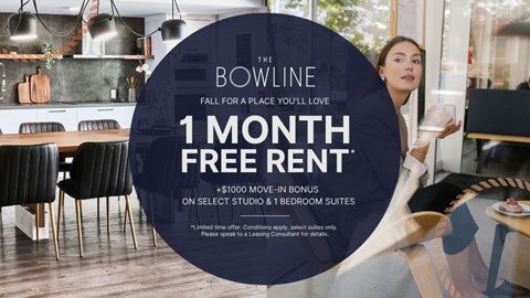 A woman is holding a glass in a modern kitchen with a 1 month free rent offer.