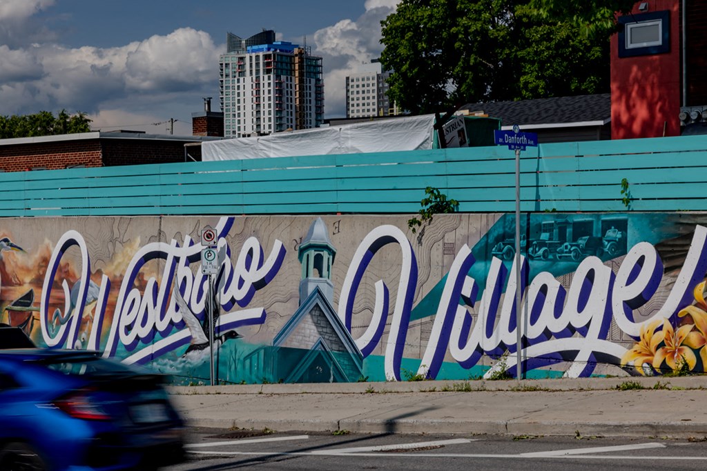 a mural on the side of a building on a city street