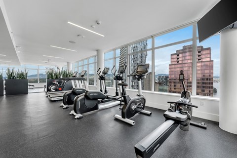 The Athletic Club A gym with a view of the city.