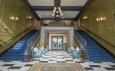 a large lobby with blue couches and a checkered floor at Camden, Ohio
