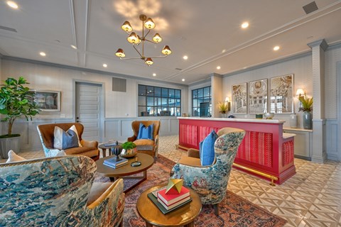 A living room with a red couch and a blue chair.