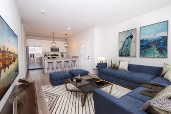 a living room with white walls and blue couches - Photo Gallery 12