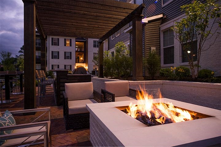 an outdoor patio with a fire pit and chairs at Kendall Park Too, Columbus