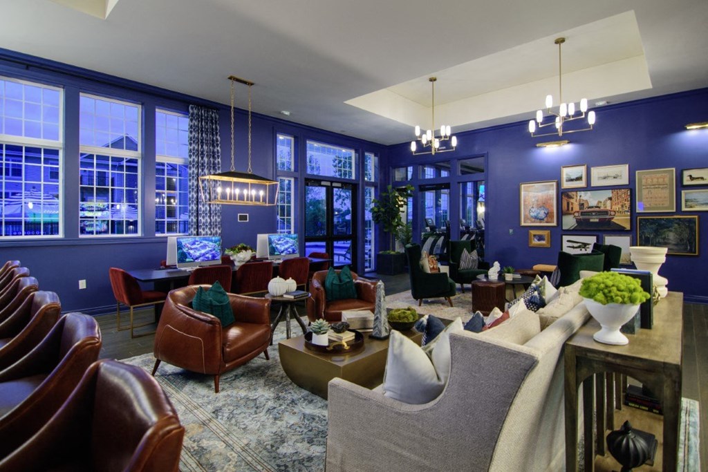 a large living room with blue walls and a lot of furniture at Elan Park, Columbus, OH 43231