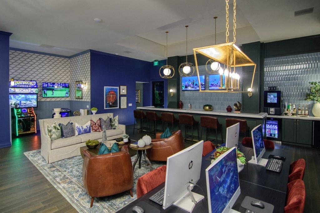 a living room with couches and a bar with computers and televisions at Elan Park, Ohio, 43231