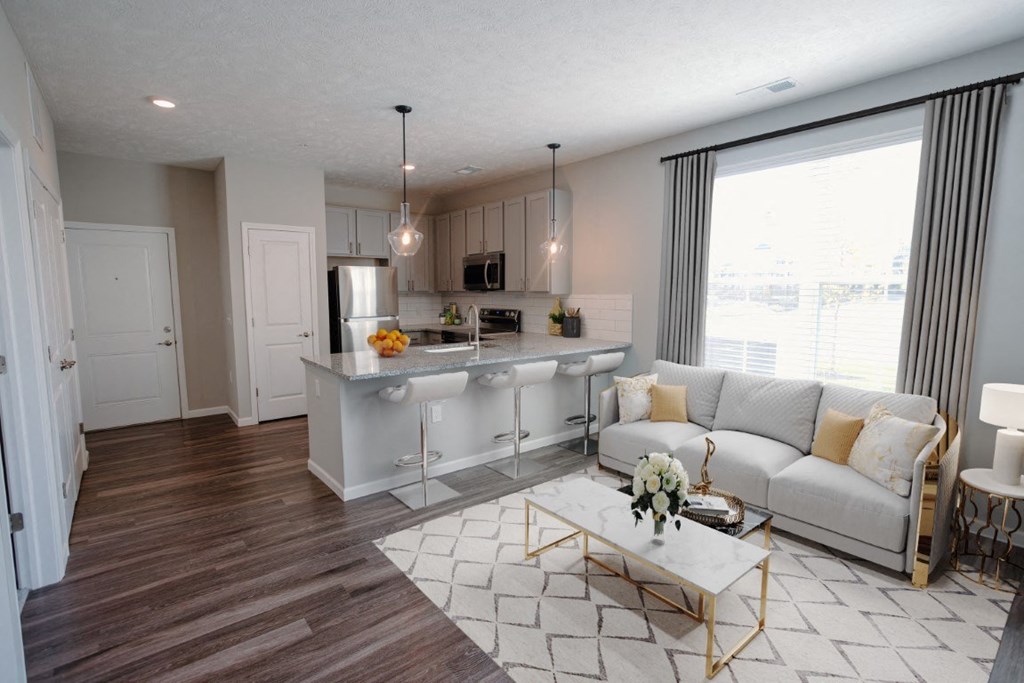 a living room and kitchen with a couch and a table at Elan Park, Ohio