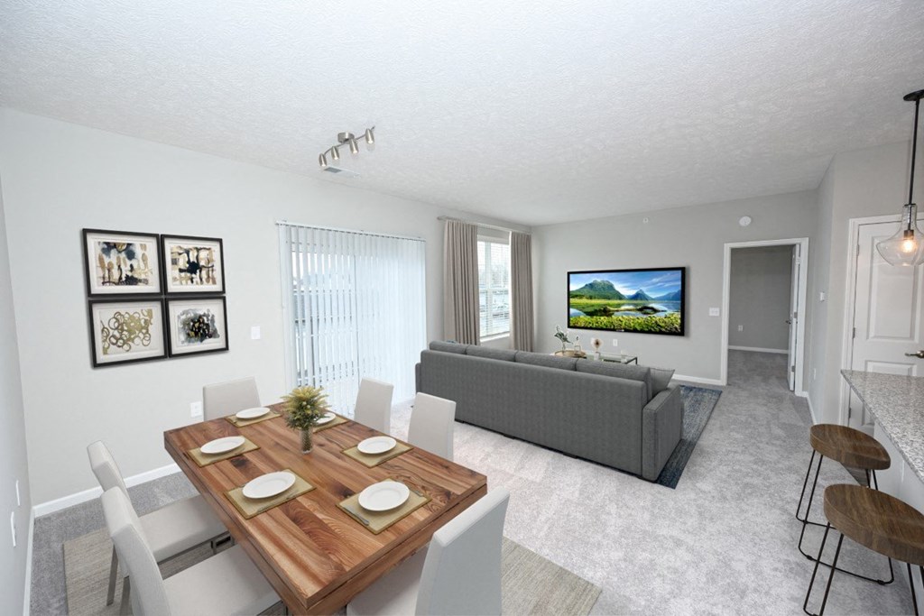 a dining room and living room with a table and a couch at Elan Park, Columbus