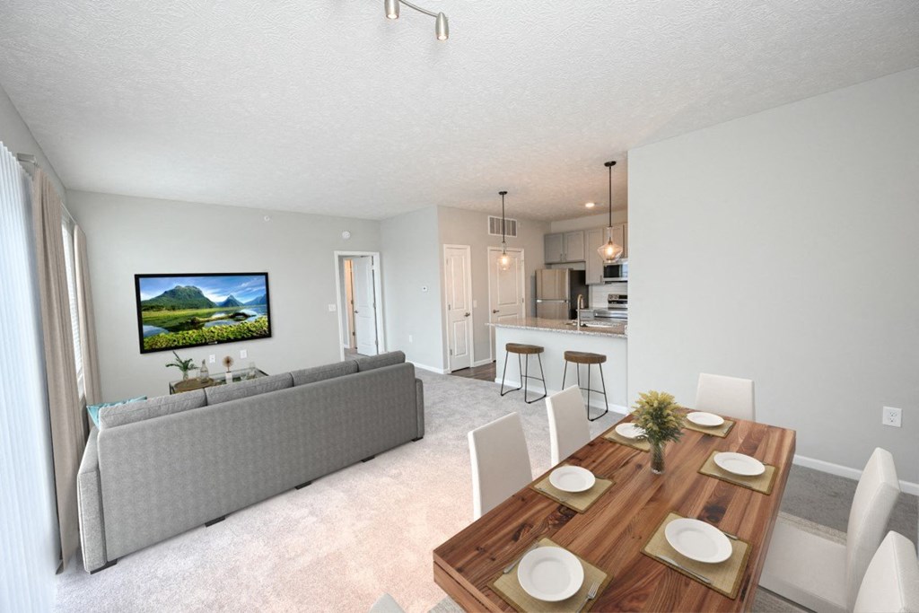 a living room and dining room with a couch and a table at Elan Park, Ohio