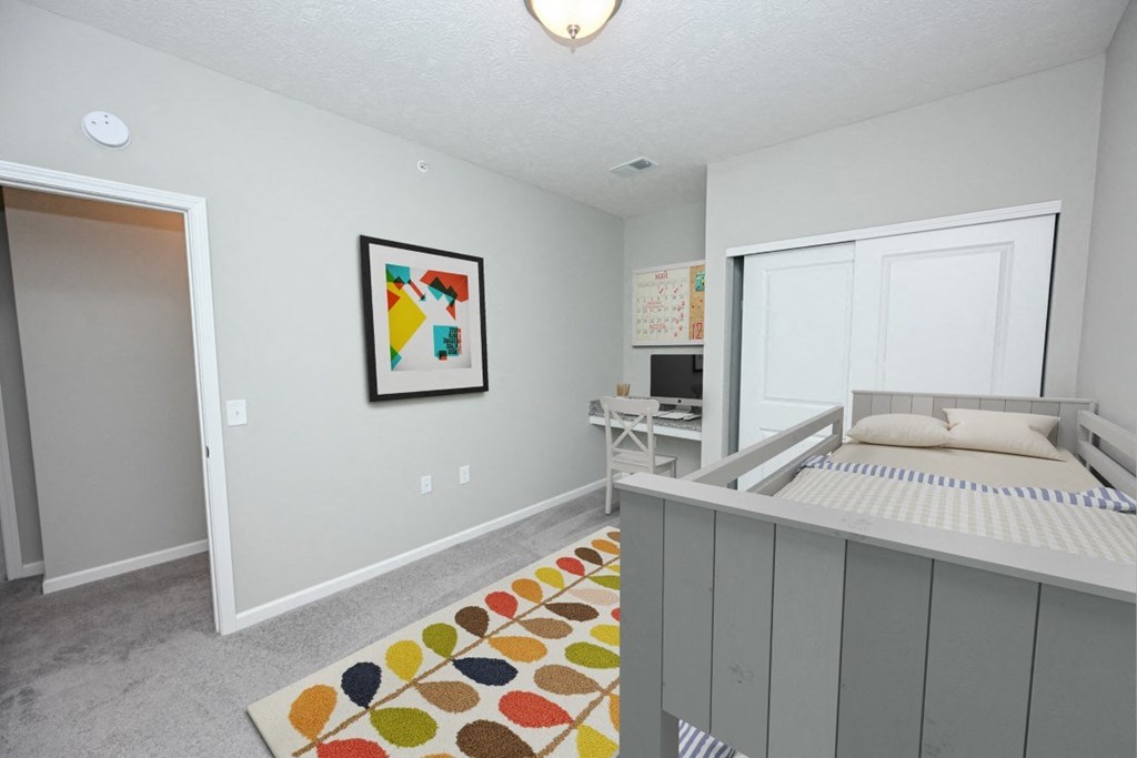 a bedroom with a bed and a desk and a window at Elan Park, Columbus