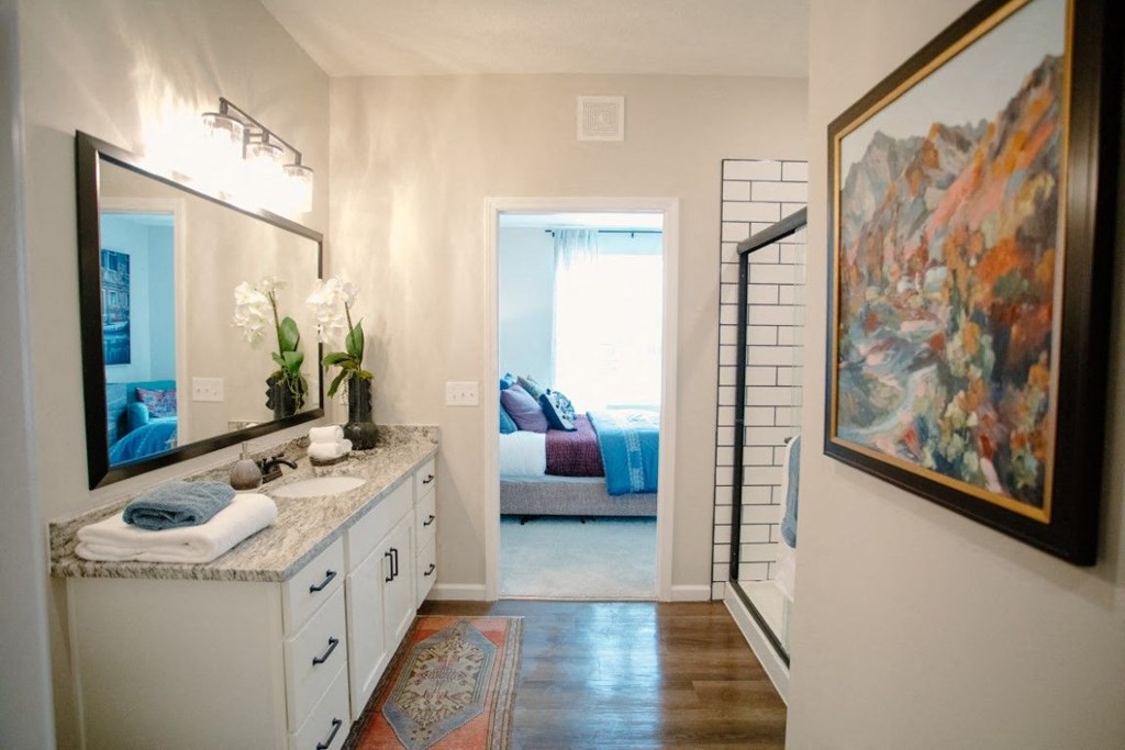 a bathroom with a sink and a mirror and a door to a bedroom at Dalton, New Albany