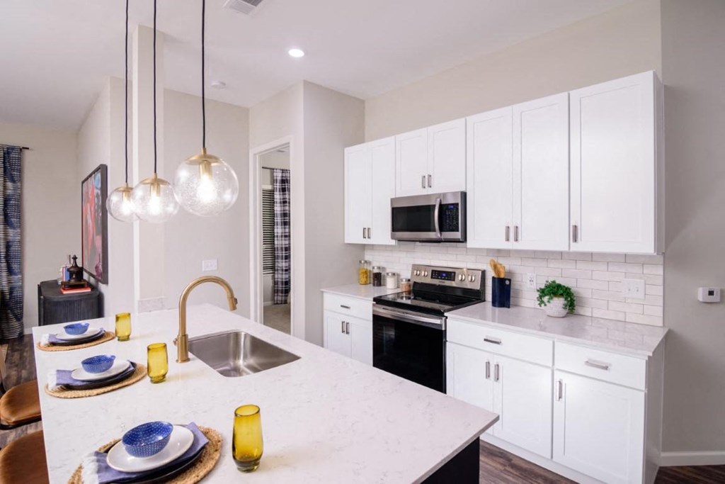 a kitchen with white cabinets and a white counter top at Essex, Columbus, OH
